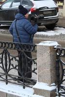 Sankt petersburg Rusland - 02 13 2023 aantrekkelijk Mens, freelance fotograaf Holding zijn camera, stedelijk avonturier nomade reist de wereld. portret van professioneel fotograaf. foto