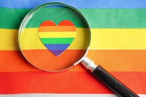 vergroten glas met hart Aan regenboog vlag, symbool van lgbt trots maand vieren jaar- in juni sociaal, symbool van homo, lesbienne, biseksueel, transgender, menselijk rechten en vrede. foto