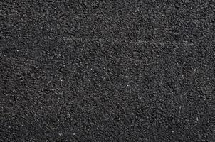 dichtbij omhoog van asfalt weg, zwart natuur asfalt achtergrond, achtergrond structuur van ruw asfalt, gemacadameerd structuur foto