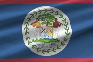 Belize vlag met groot vouwen golvend dichtbij omhoog onder de studio licht binnenshuis. de officieel symbolen en kleuren in banier foto