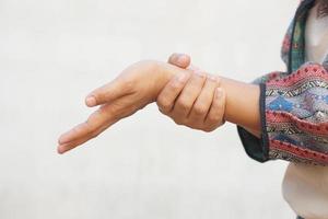 Aziatisch vrouw hebben spier zwakheid in haar handen foto