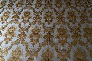 middeleeuws kleding stof structuur achtergrond goud en wit foto