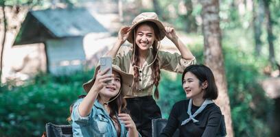 Aziatisch mooi vrouw en vriendin gebruik smartphone selfie Aan camping foto