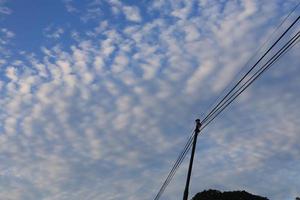 wit wolken en zon tegen een achtergrond van blauw lucht foto