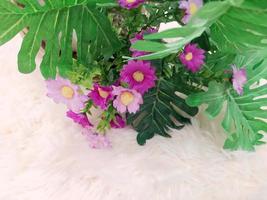 detailopname van kunstmatig bloemen Aan een licht gekleurd tapijt. foto