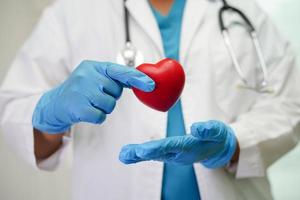 aziatische vrouw arts met rood hart voor gezondheid in het ziekenhuis. foto