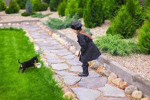 weinig meisje spelen met puppy hond foto