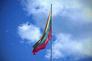 vlag van Litouwen Aan blauw lucht met wolken achtergrond foto