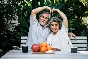 bejaarde echtpaar spelen en eten wat fruit foto