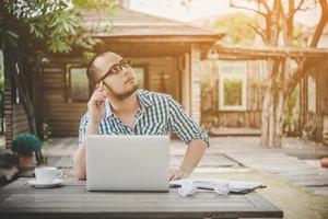 jonge zakenman met bril werken op de werkplek, gestrest voelen, laptop kijken