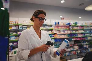 apotheker vrouw met bril werken Bij de apotheek teller foto