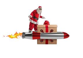 de kerstman claus levert cadeaus met een snel ruimte raket foto