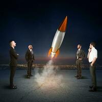 team van mensen uit het bedrijfsleven looks begin een raket. concept van bedrijf opstarten en nieuw bedrijf. 3d weergave. foto