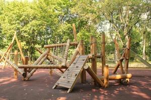 houten modern ecologisch veiligheid kinderen buitenshuis speelplaats uitrusting in openbaar park. natuur architectuur bouw speelhuisje in stad. kinderen rust uit en kinderjaren concept. idee voor spellen Aan lucht. foto