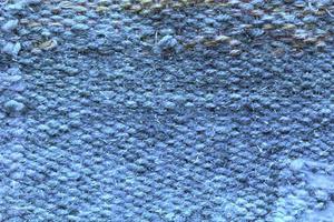 geweven blauw wol kleding stof textuur. hand- gebreid textiel canvas achtergrond. lapwerk tapijt achtergrond. fabriek materiaal draden. abstract ontwerp. detailopname, model, top visie foto
