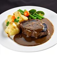 rundvlees steak met bruin saus en aardappel in wit bord foto