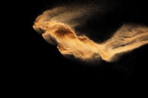 zand explosie geïsoleerd Aan zwart achtergrond. bevriezen beweging van zanderig stof plons.zand structuur concept. foto