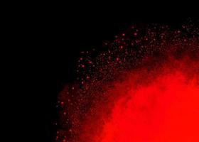 rood kleur stof deeltje explosie wolk Aan zwart achtergrond foto