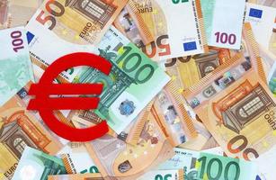 rood voelde euro valuta symbool Aan 50 en 100 euro bankbiljetten achtergrond. financieel, bank, geld, economie, bedrijf concept. plaats voor tekst. foto