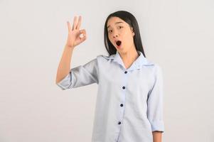portret van jong Aziatisch vrouw aan het doen OK teken met hand- en vingers over- geïsoleerd wit achtergrond foto
