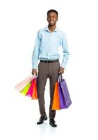 gelukkig Afrikaanse Amerikaans Mens Holding boodschappen doen Tassen Aan wit achtergrond foto