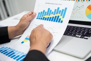 Aziatische accountant werkt en analyseert financiële rapporten projectboekhouding met grafiekgrafiek in modern kantoor, financiën en bedrijfsconcept. foto