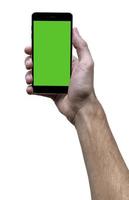 mannetje hand- Holding zwart mobiele telefoon met groen scherm Bij geïsoleerd wit achtergrond. foto