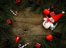 Kerstmis boom takken met Kerstmis decoraties en sneeuwman Aan houten structuur foto