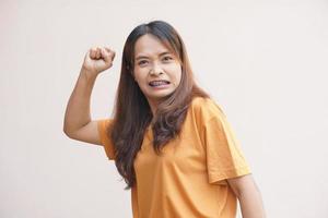 Aziatisch vrouw verhogen haar vuist uit van woede foto