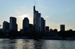 wolkenkrabbers door de rivier. zonsondergang. stad landschap. foto