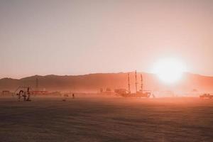 mensen wandelen naar zonsondergang Bij een festival in de woestijn Bij de brandend Mens festival. foto