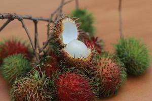 ramboetan fruit welke is roodachtig groen in kleur hebben zoet smaak geïsoleerd Aan tafel. voedsel concept foto. foto