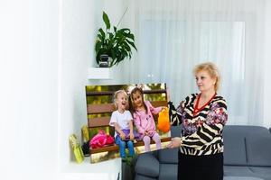 een gelukkig ouderen blond vrouw is Holding een groot muur foto canvas Bij huis