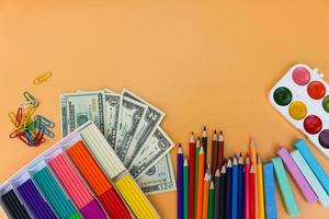 school- benodigdheden en dollar. concept is naar kopen schrijfbehoeften voorwerpen. top visie. foto