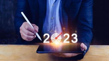 bedrijf doelwit en doel 2023 icoon, hand- richten Holding 2023 virtueel scherm, begin nieuw jaar 2023 met een doel plan, actie plan, strategie, nieuw jaar bedrijf visie. foto