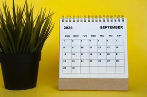 september 2024 maand kalender met tafel fabriek Aan geel Hoes achtergrond. maandelijks kalender concept foto