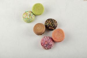 kleurrijke zoete kleine donuts op een witte achtergrond foto