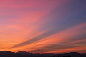 kleurrijk zonsondergang over- de berg heuvels. natuur achtergrond foto