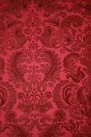een oud patroon Aan tapijtwerk stof.vintage retro achtergrond rood. foto