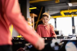 broers spelen tafel Amerikaans voetbal in kinderen Speel centrum. foto