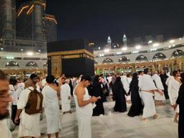 mekka, saudi Arabië, maart 2023 - gedurende de maand van Ramadan, pelgrims van allemaal over- de wereld uitvoeren tawaf in de omgeving van de kabah Bij de masjid al-haram in mekka.. foto
