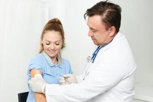 mannetje dokter in een wit jas een injectiespuit in de handen van een injectie covid vaccinatie foto