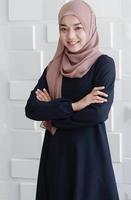 mooie moslim Aziatische zakenvrouw staat lachend met geluk in kantoor