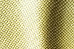 kogelvrij materiaal aramide. aramide kevlar achtergrond. gouden kevlar structuur en patroon. foto