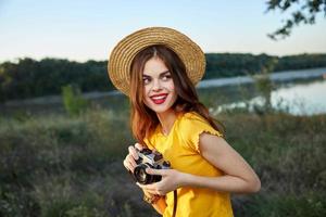 vrouw cartograaf met hoed rood lippen camera vers lucht natuur foto