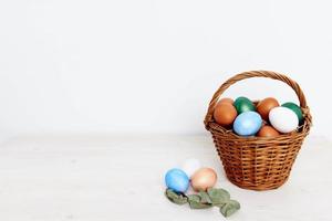 geschilderd Pasen eieren in een mand Aan een licht achtergrond kopiëren ruimte foto