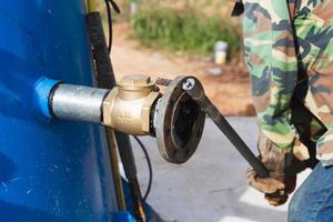 leger met werk gereedschap werken loodgieter, leger loodgieter gelast groot pijpen foto