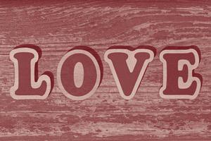 woord liefde gemaakt van houten brieven Aan houten bord foto