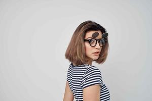 vrouw in gestreept t-shirt zonnebril studio geïsoleerd achtergrond foto