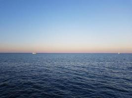 zeegezicht zee met kalmte water en Doorzichtig lucht foto